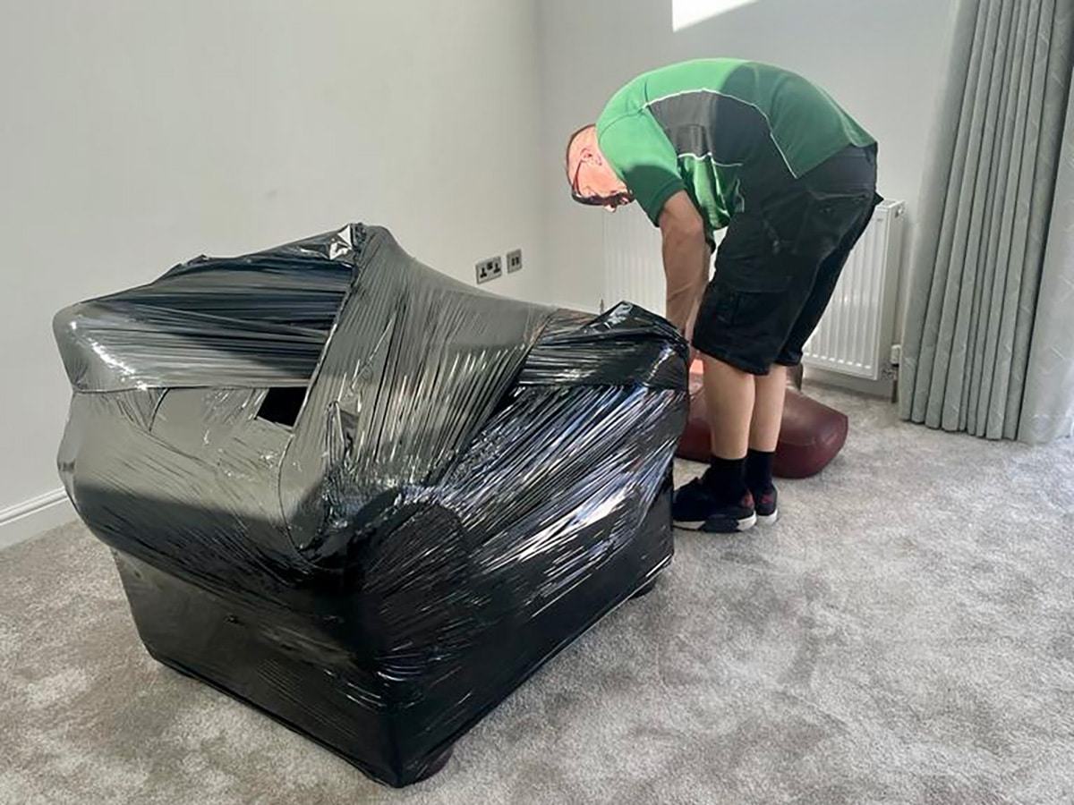 Carefully packing kitchen items for a house move in Nottingham