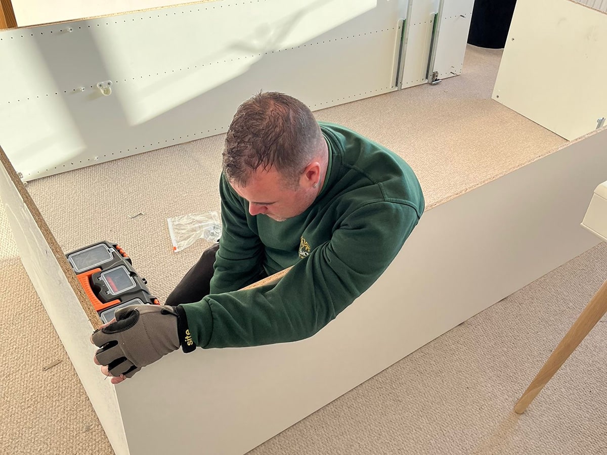 Tee's Removals team member reassembling a bed as part of their removals service