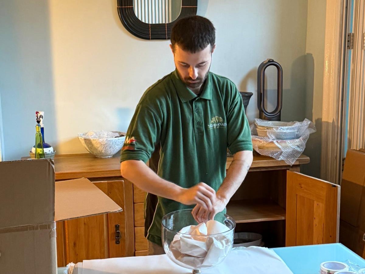 Carefully packing household items before a move in Nottingham