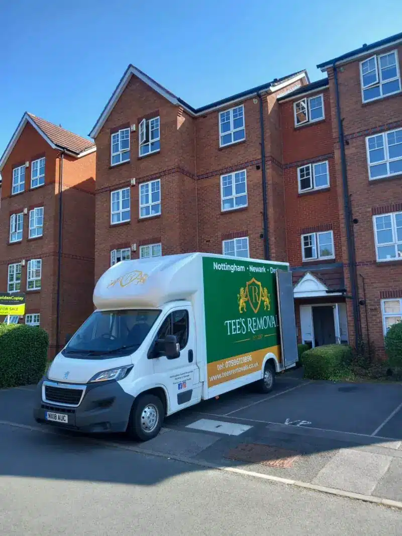 Tee's Removals branded luton van parked outside a residential apartment block in Nottingham